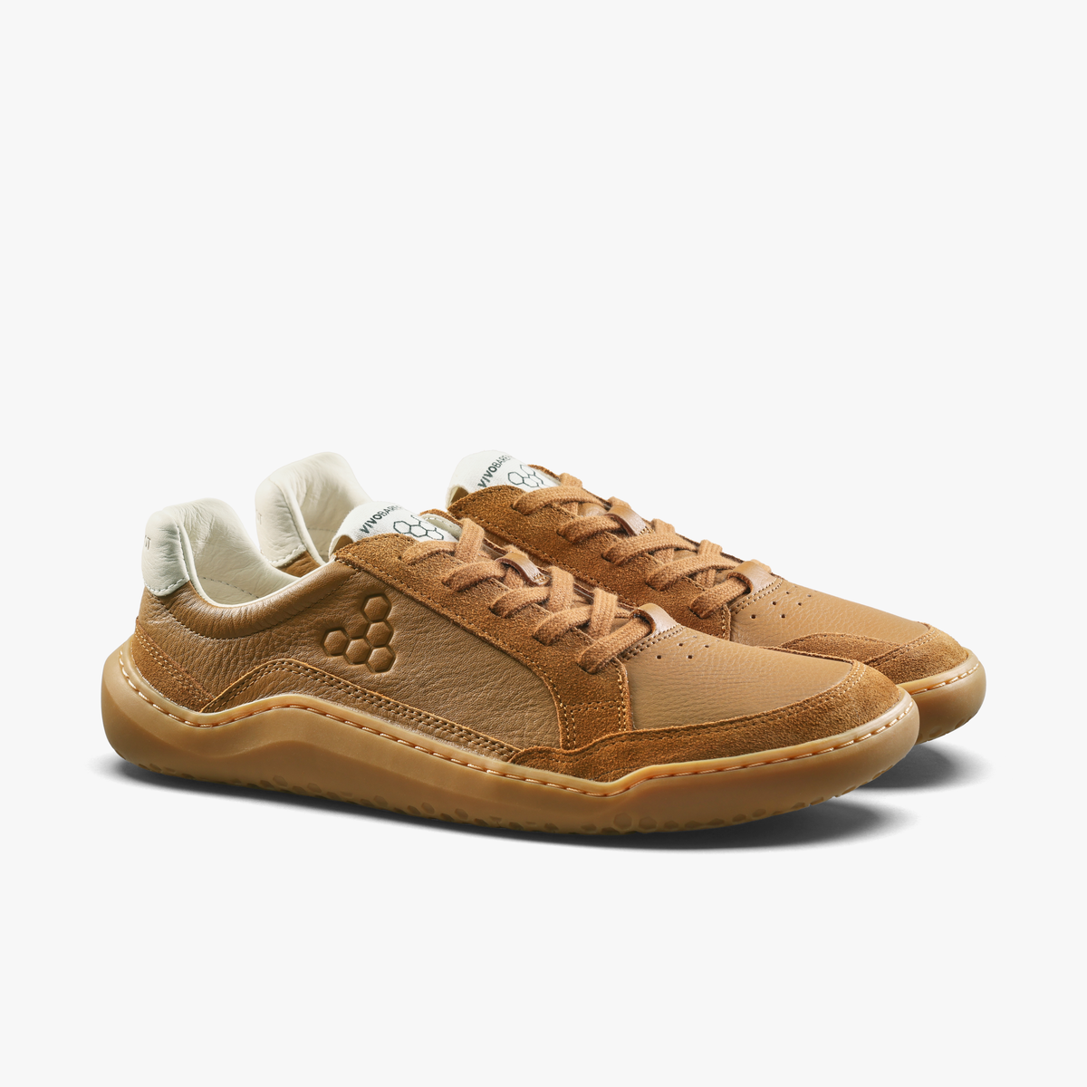 Par tan lædersneakers med snørebånd i samme farve, set skråt forfra