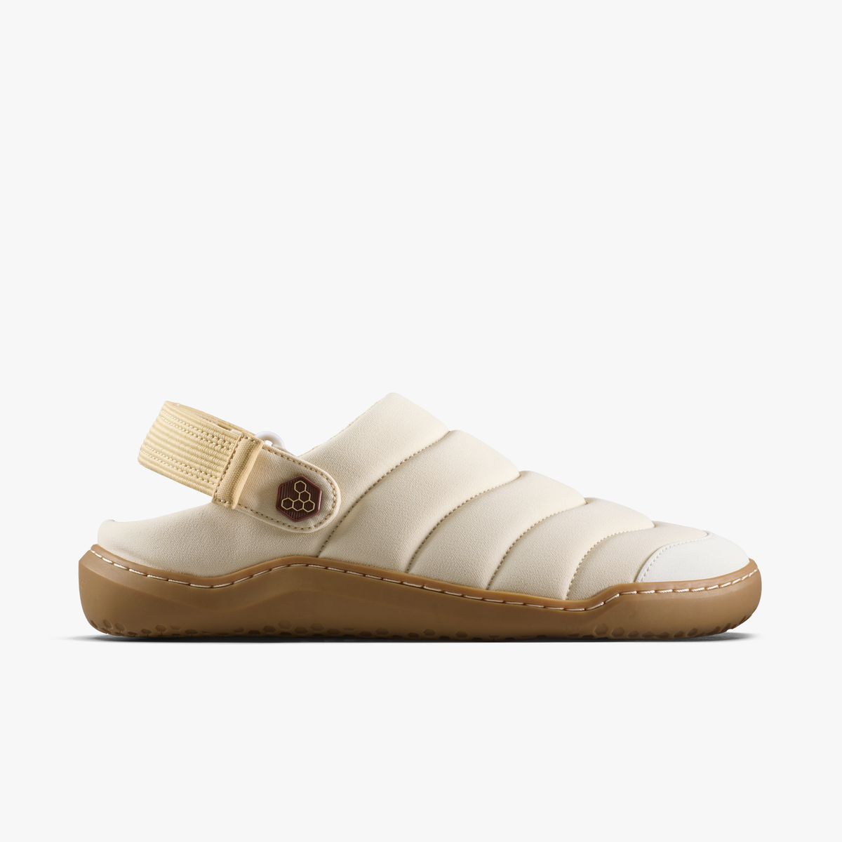 Vivobarefoot Gobi Wavey Mule i sand quiltet tekstil, barfodssko set fra ydersiden